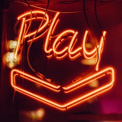 neon sign with the word "play"
